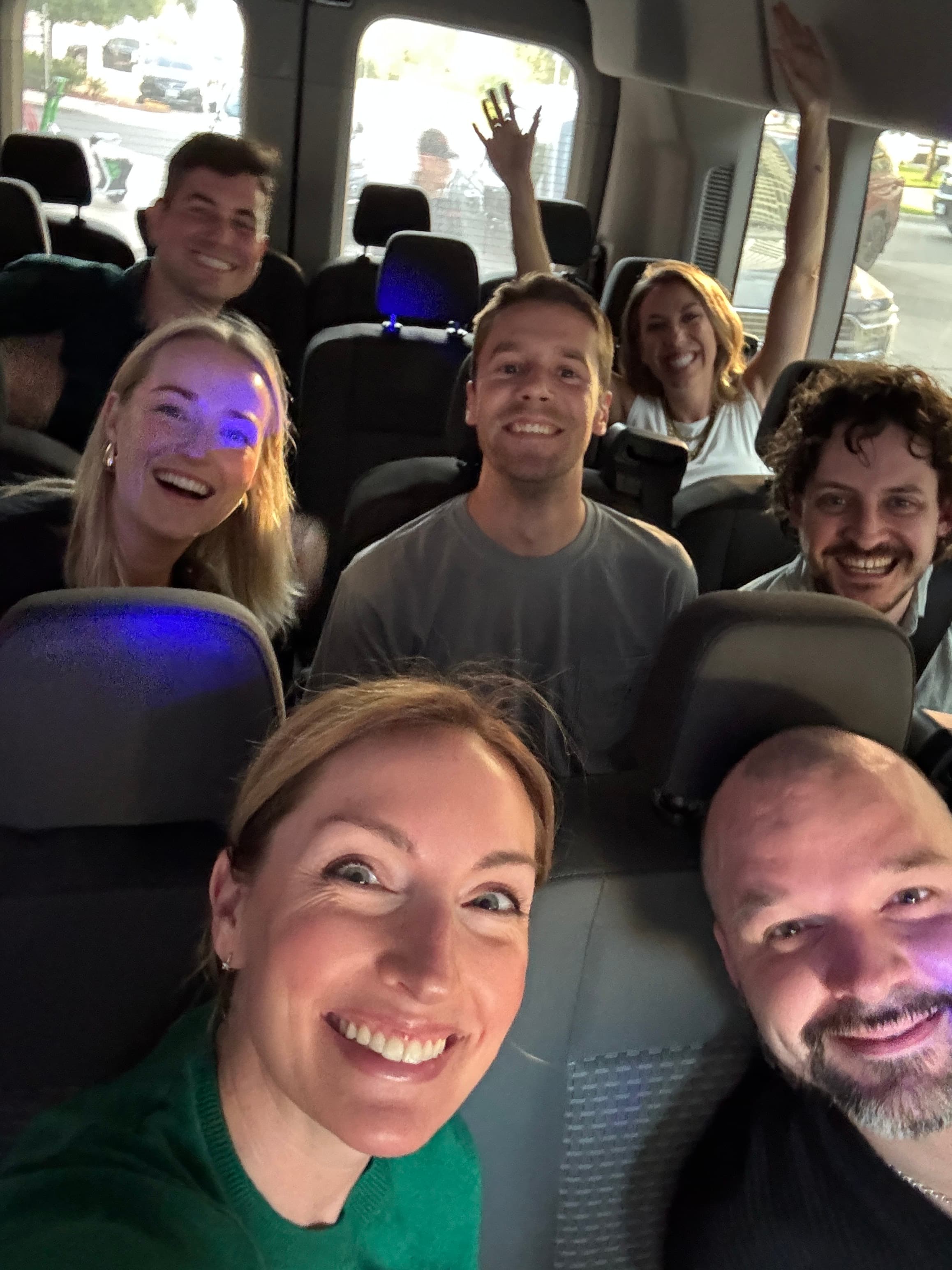 Kate and teammates taking a group selfie in a van